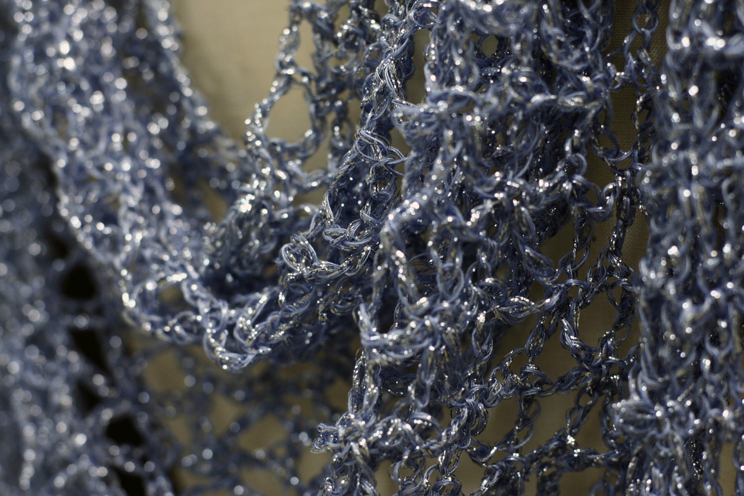 Side view of the blue shawl, the shimmering thread catching the light.