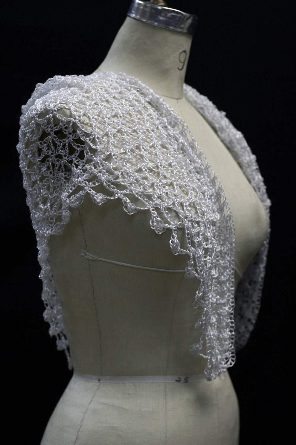 White shawl draped to show how it falls over the shoulders.