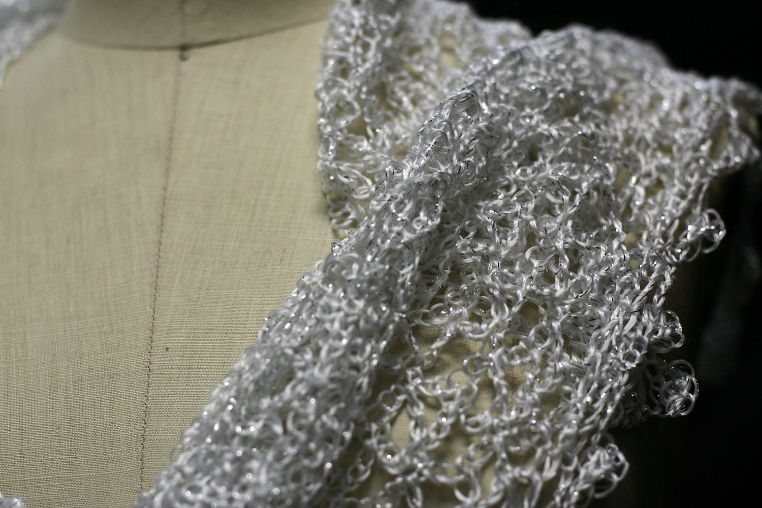 Side view of the white shawl, the shimmering thread catching the light.