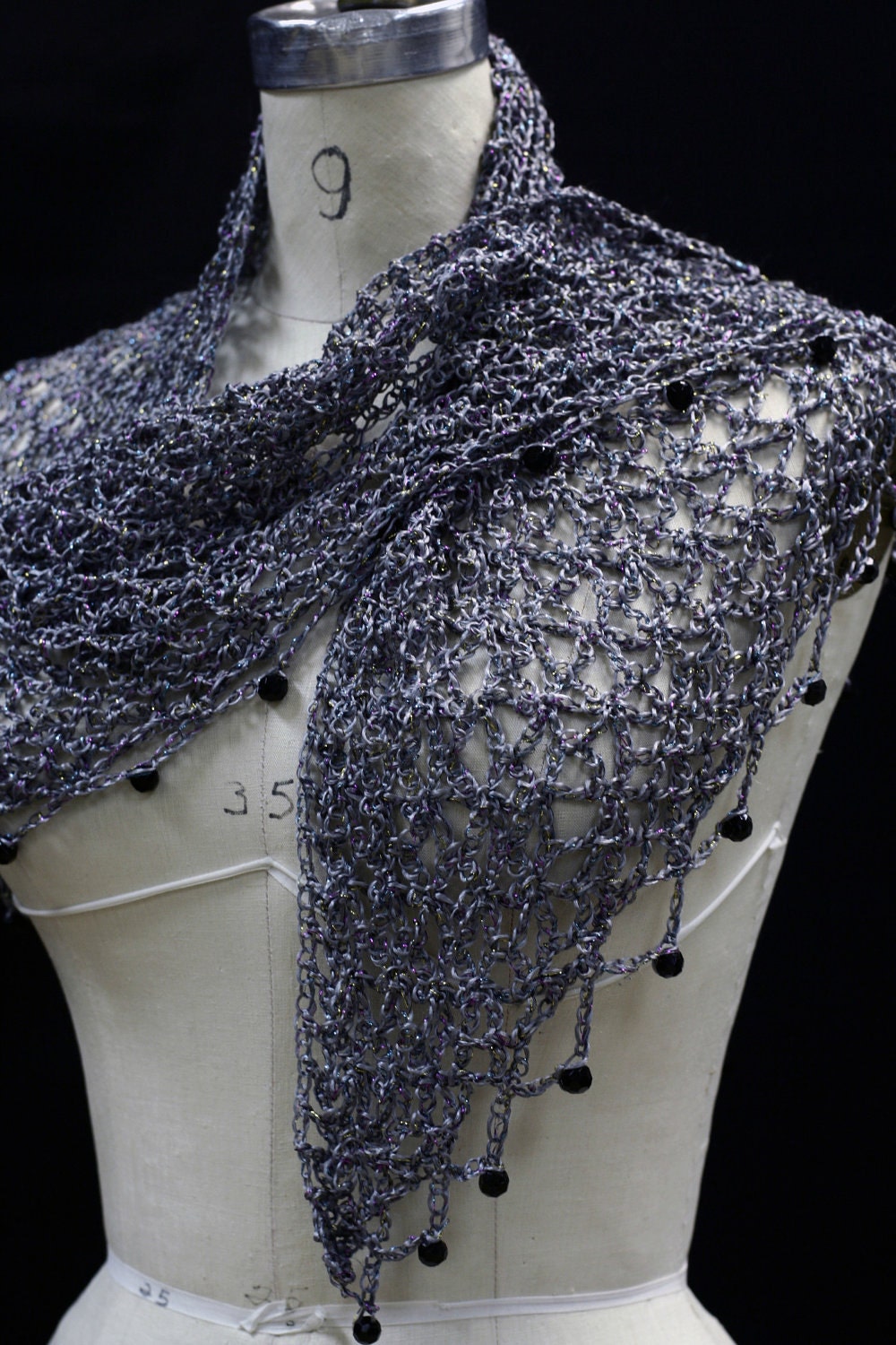 Close-up of the gray crochet openwork and beaded edge of the shawl.