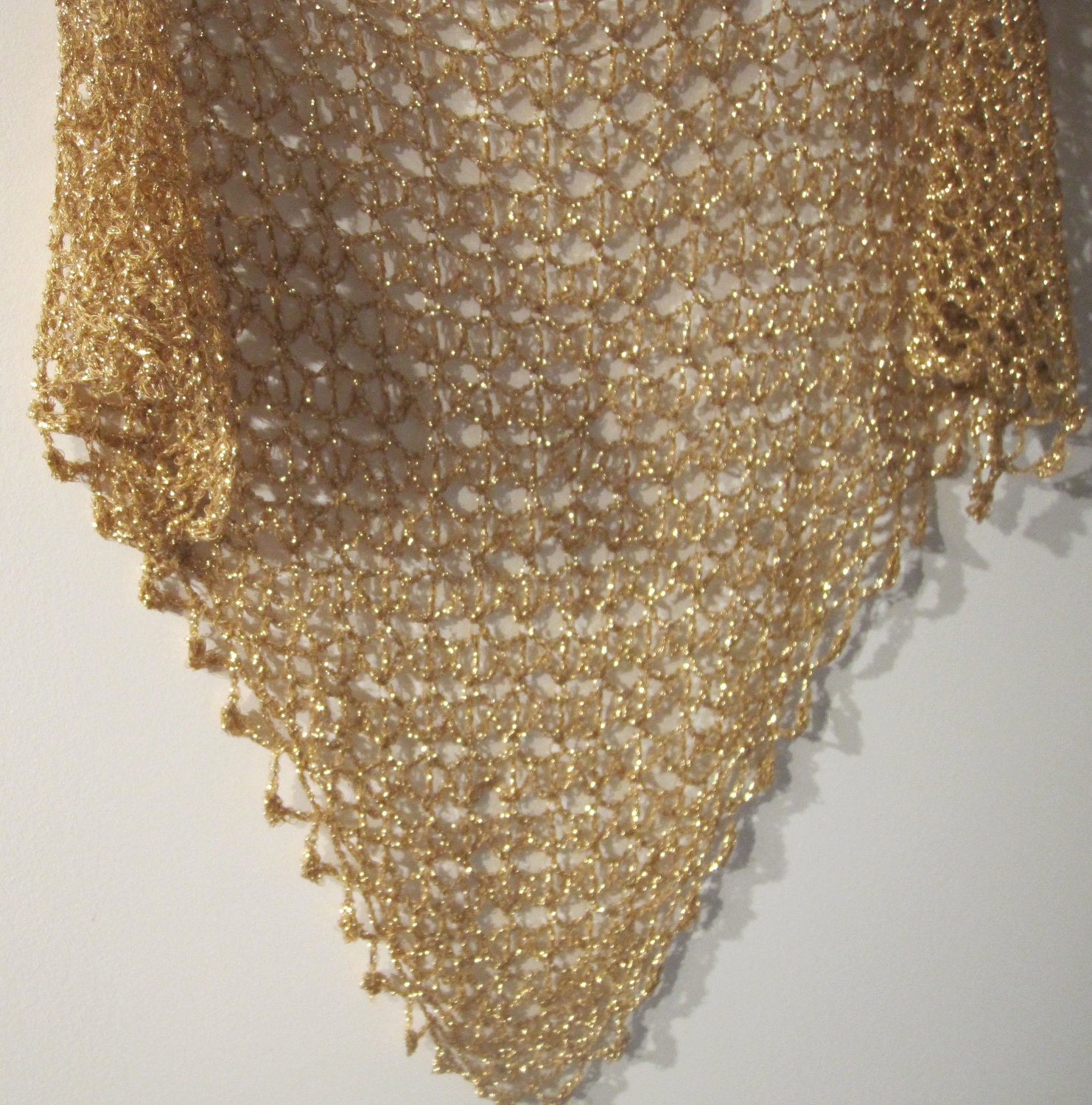 Close-up of the champagne gold crochet openwork and beaded edge of the shawl.