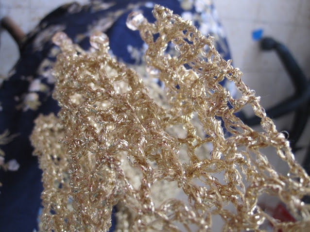 Champagne gold shawl draped to show how it falls over the shoulders.