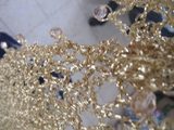 Gold Shawl — Side view of the champagne gold shawl, the shimmering thread catching the light.