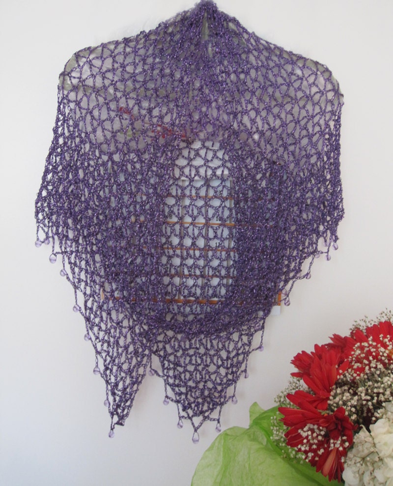 Side view of the plum purple shawl, the shimmering thread catching the light.