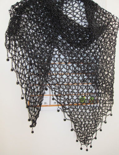 Close-up of the black crochet openwork and beaded edge of the shawl.