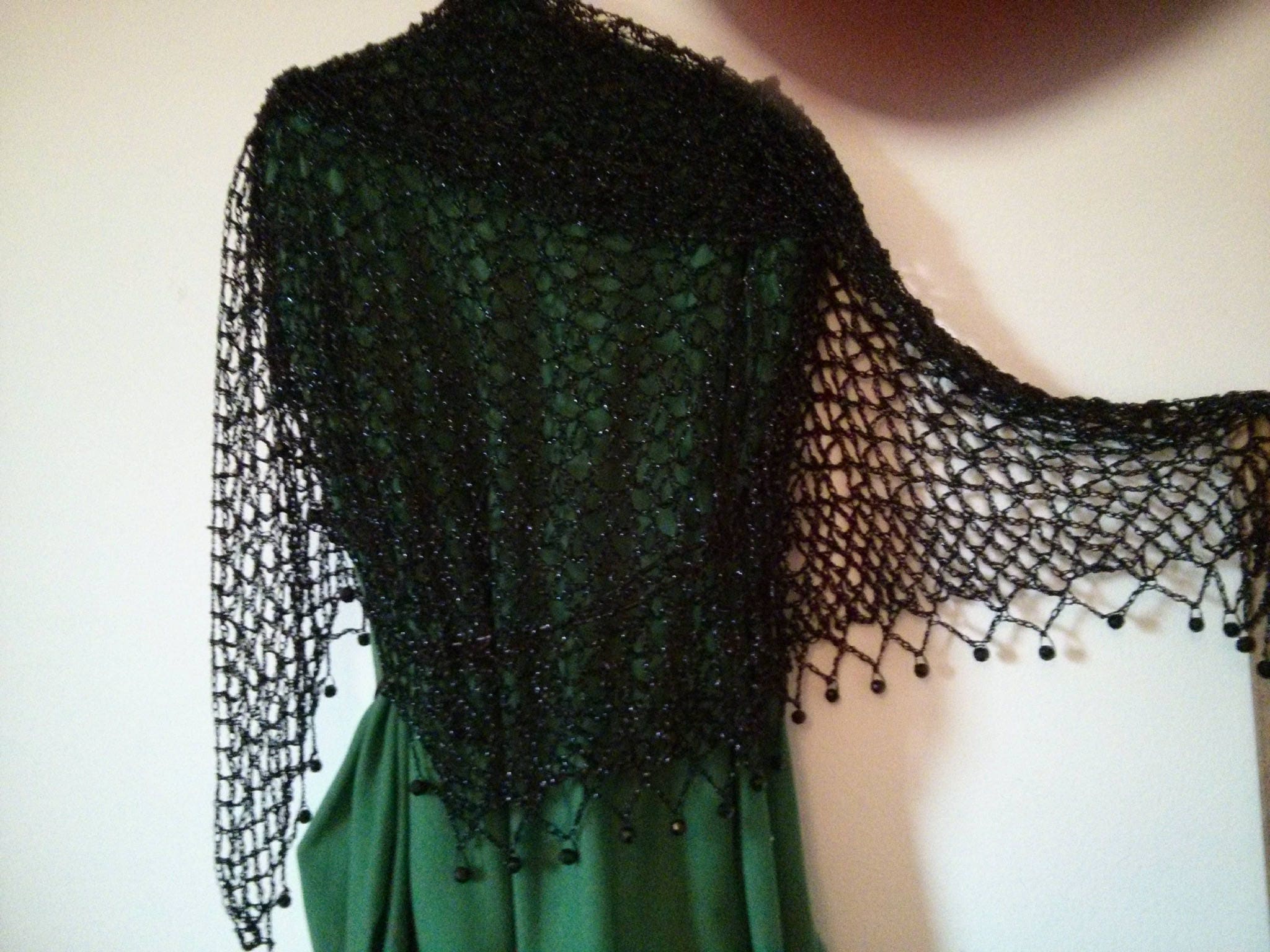 Detail of the hand stitches along the beaded edge of the black shawl.