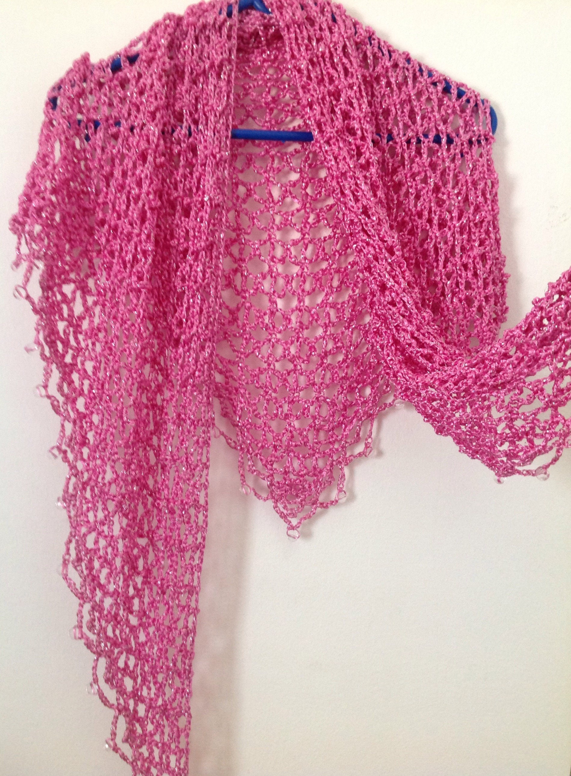 Close-up of the blush pink crochet openwork and beaded edge of the shawl.