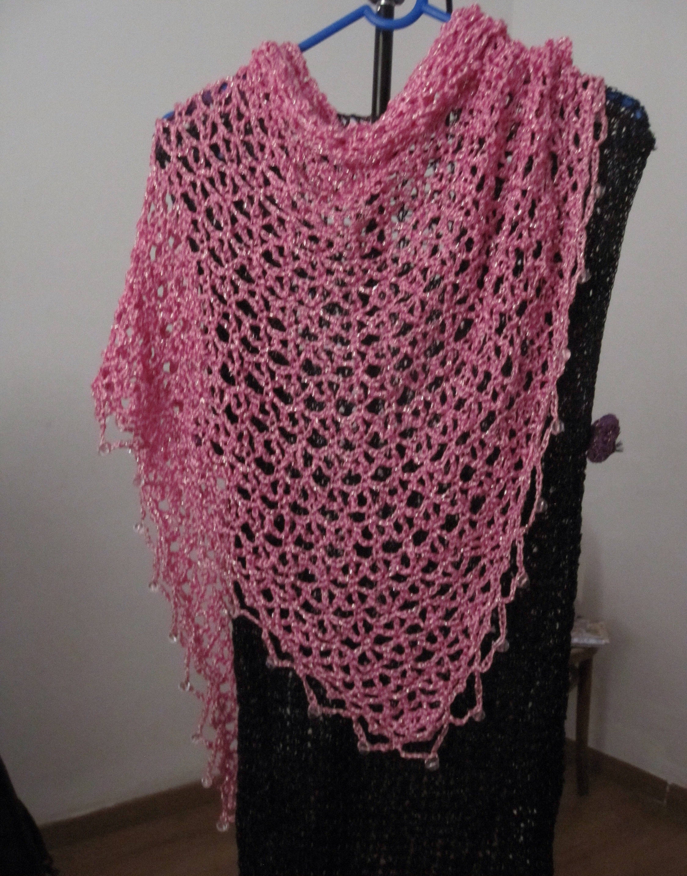 Blush pink shawl draped to show how it falls over the shoulders.