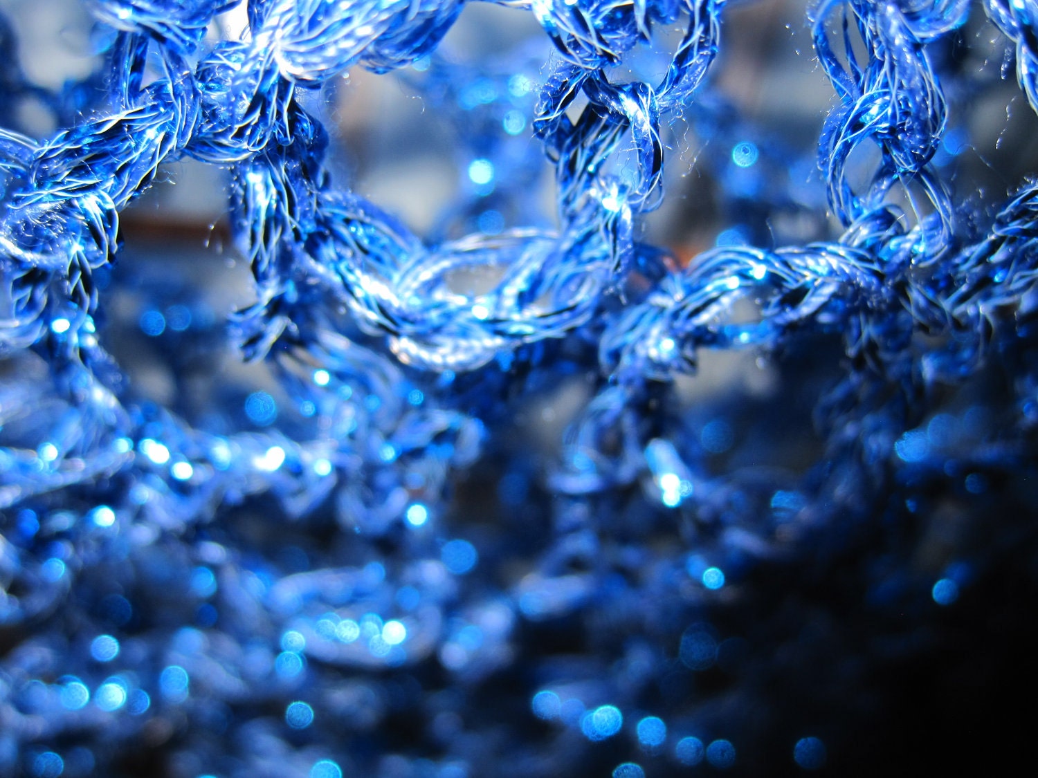 Side view of the blue shawl, the shimmering thread catching the light.
