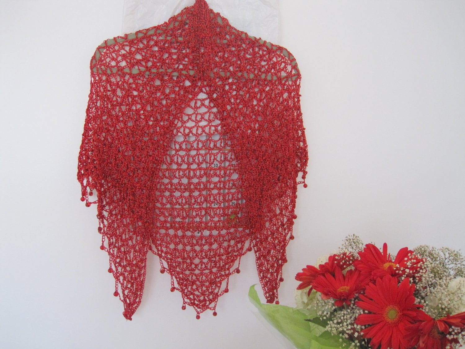 Red shawl, full view of the hand-crocheted piece.