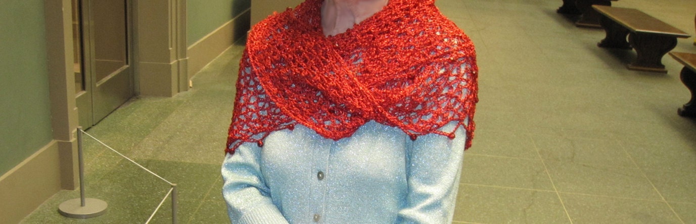 Side view of the red shawl, the shimmering thread catching the light.