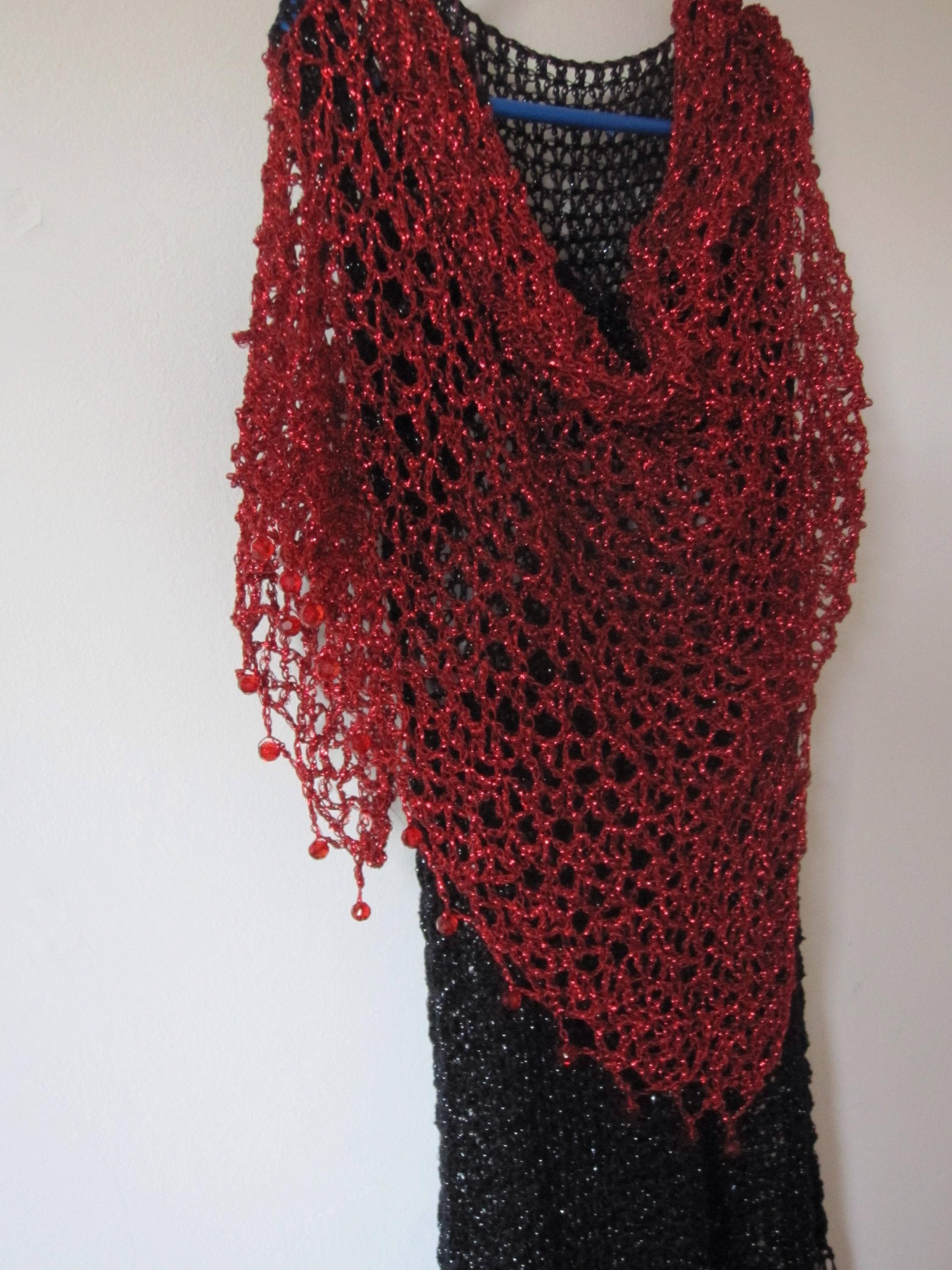 Red shawl, full view of the hand-crocheted piece.