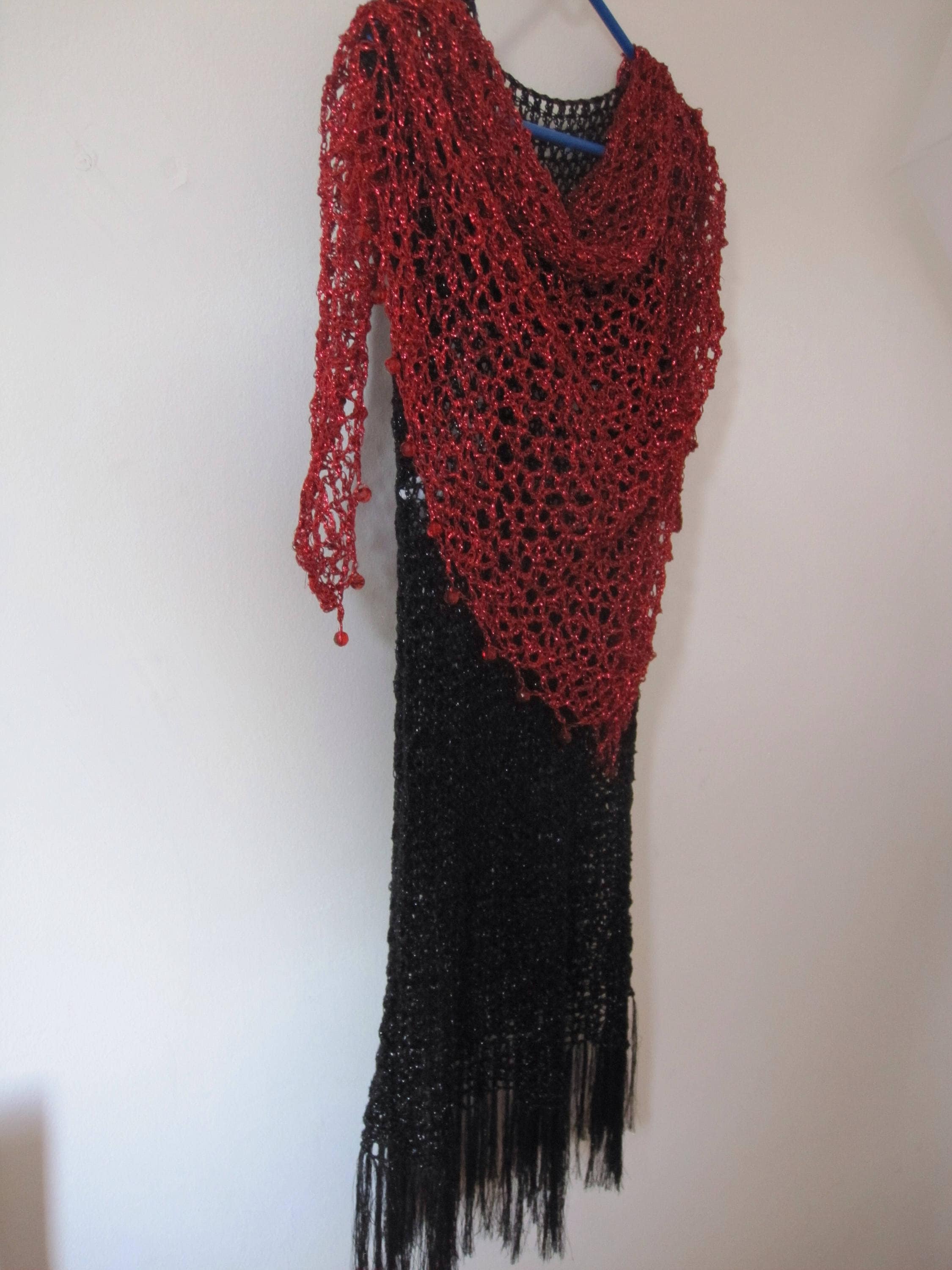 Side view of the red shawl, the shimmering thread catching the light.