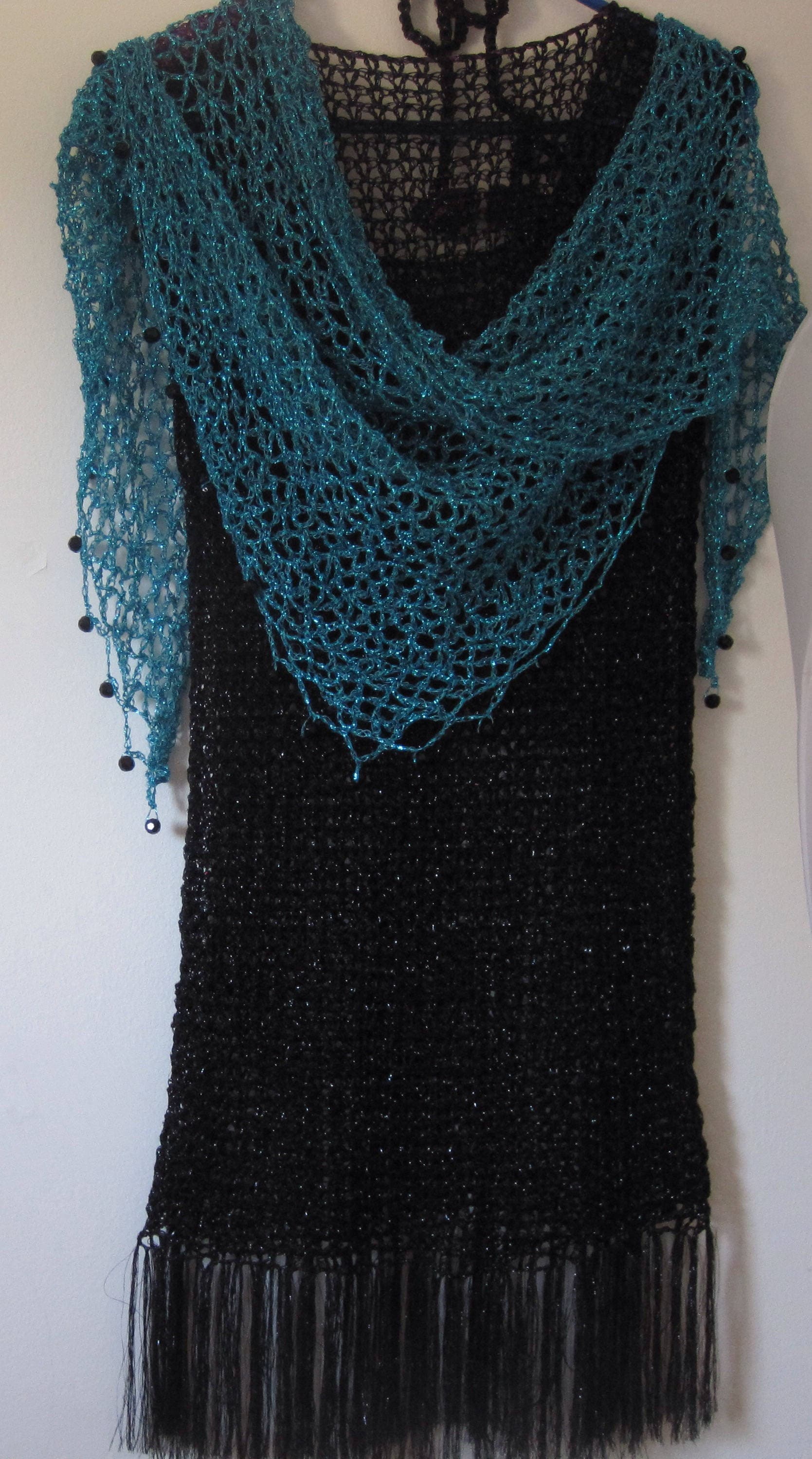 Close-up of the turquoise crochet openwork and beaded edge of the shawl.