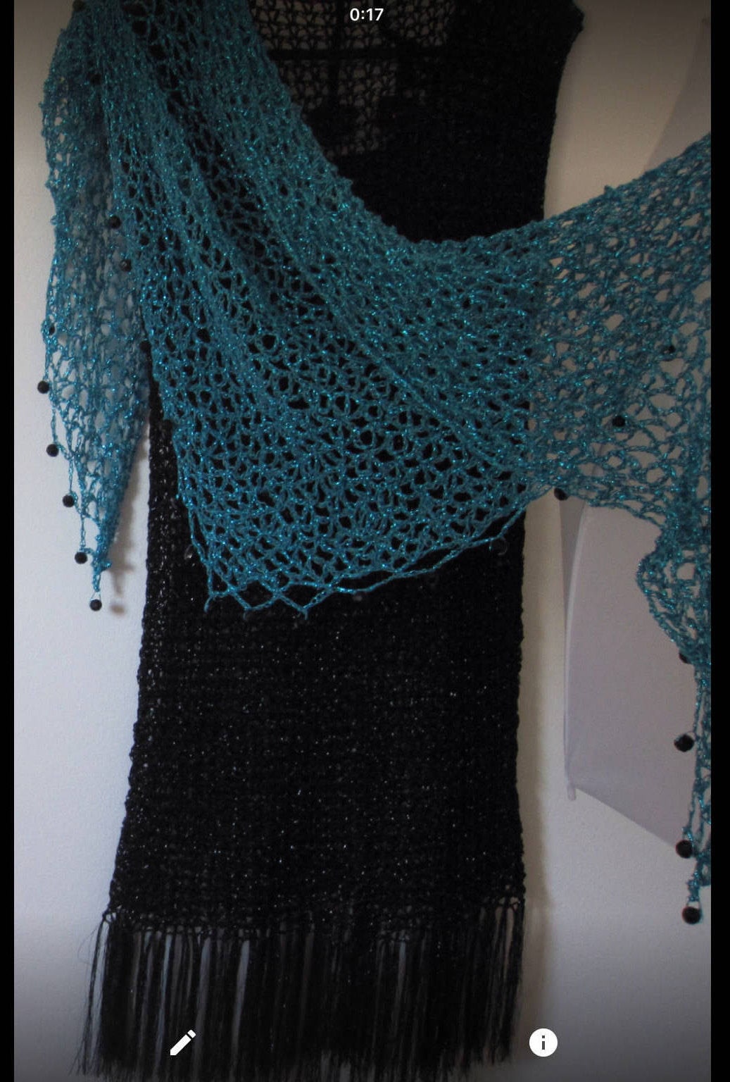Turquoise shawl draped to show how it falls over the shoulders.