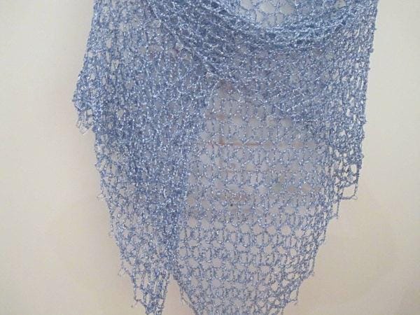 Close-up of the sky blue crochet openwork and beaded edge of the shawl.