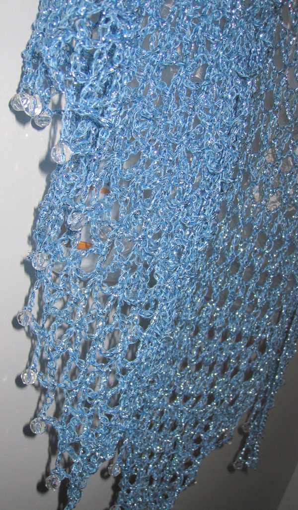 Side view of the sky blue shawl, the shimmering thread catching the light.