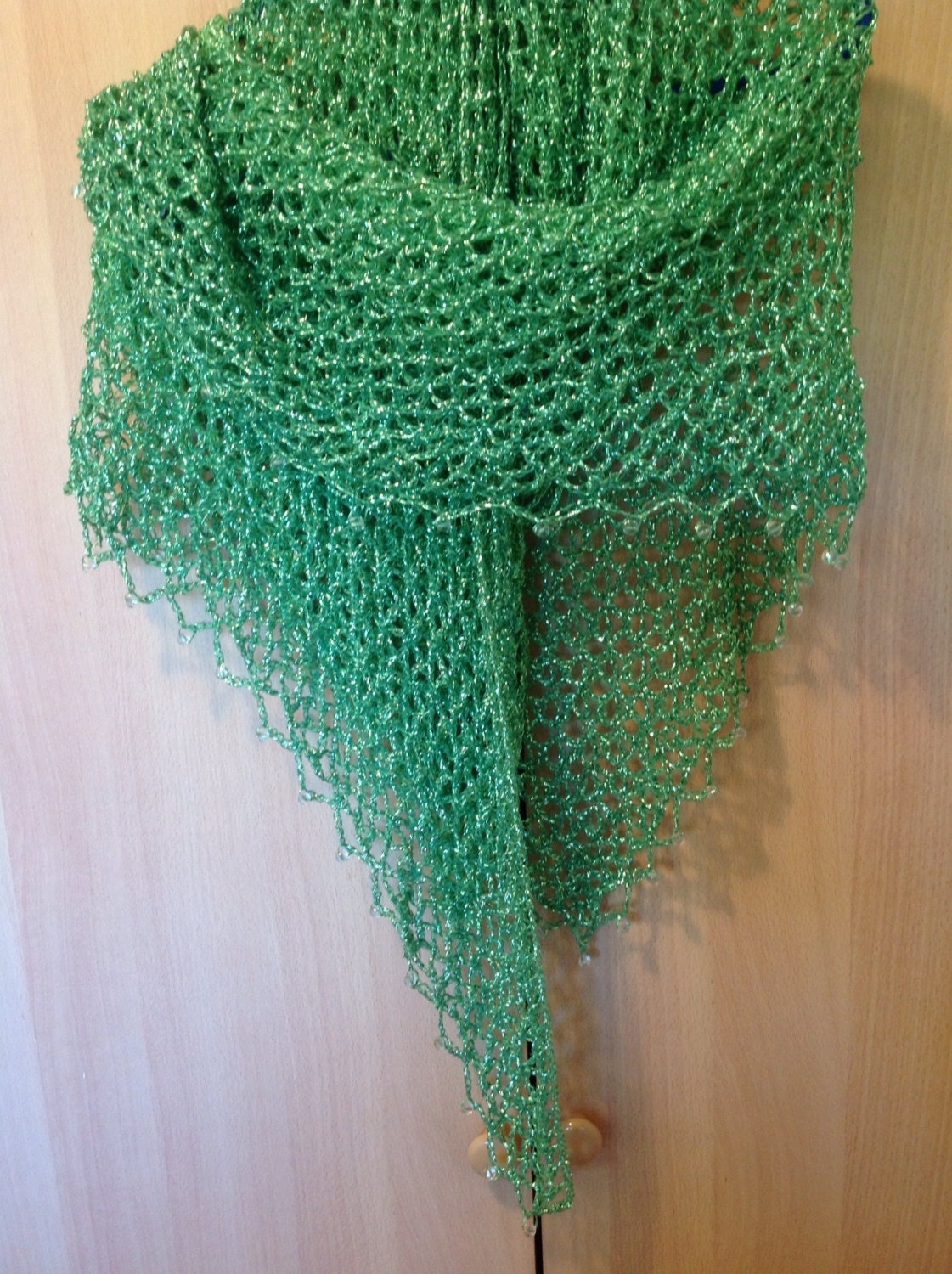 Side view of the green shawl, the shimmering thread catching the light.