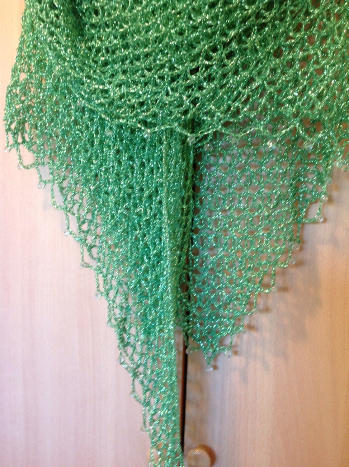 Detail of the hand stitches along the beaded edge of the green shawl.