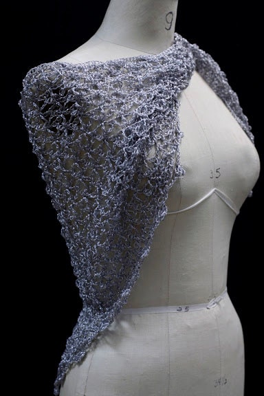 Side view of the silver shawl, the shimmering thread catching the light.