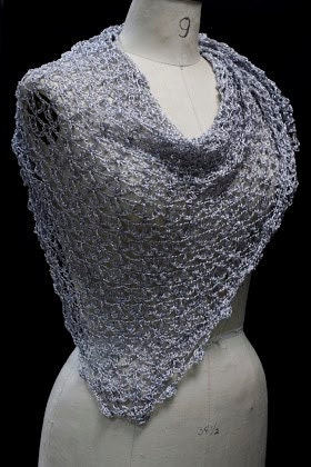 Detail of the hand stitches along the beaded edge of the silver shawl.