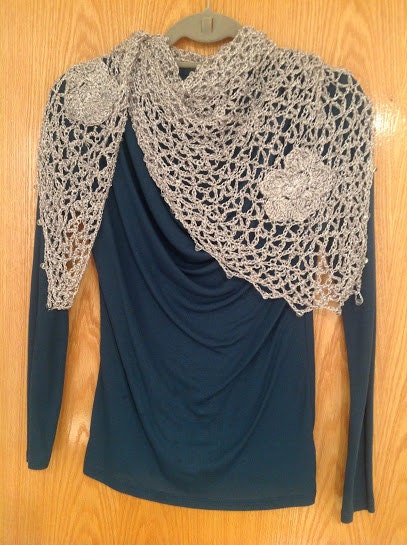 Close-up of the silver crochet openwork and beaded edge of the shawl.