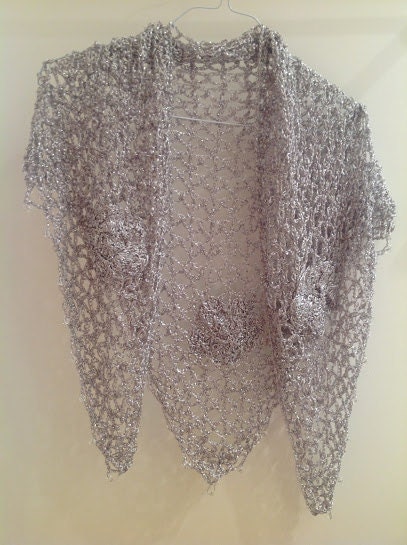 Silver shawl draped to show how it falls over the shoulders.