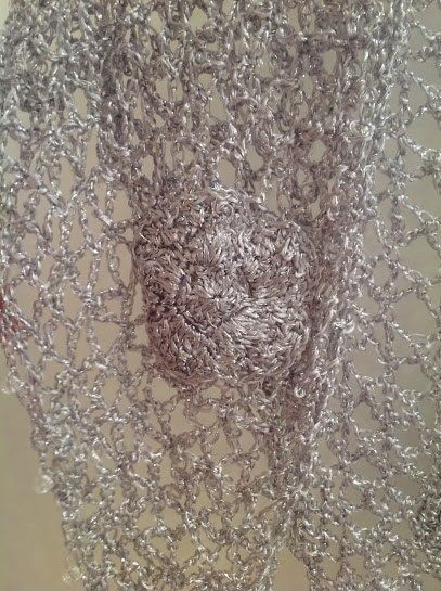 Side view of the silver shawl, the shimmering thread catching the light.