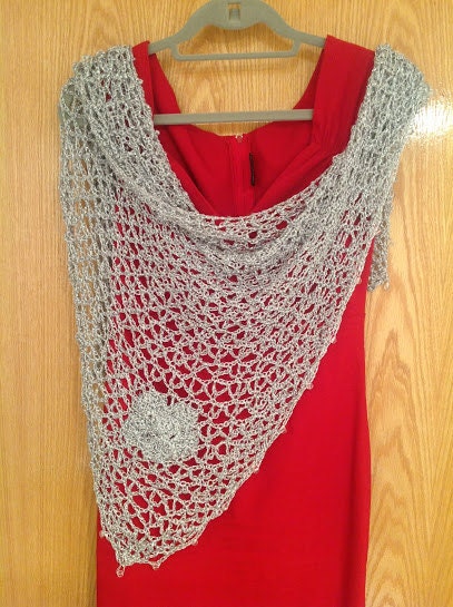 Detail of the hand stitches along the beaded edge of the silver shawl.