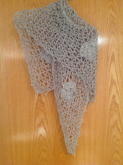 Silver shawl laid flat, showing the full triangular shape.