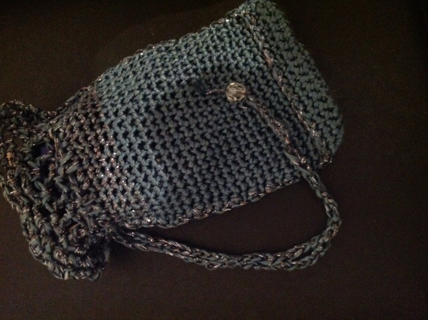 Gray phone pouch draped to show how it falls over the shoulders.