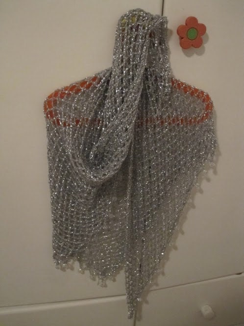 Silver shawl draped to show how it falls over the shoulders.