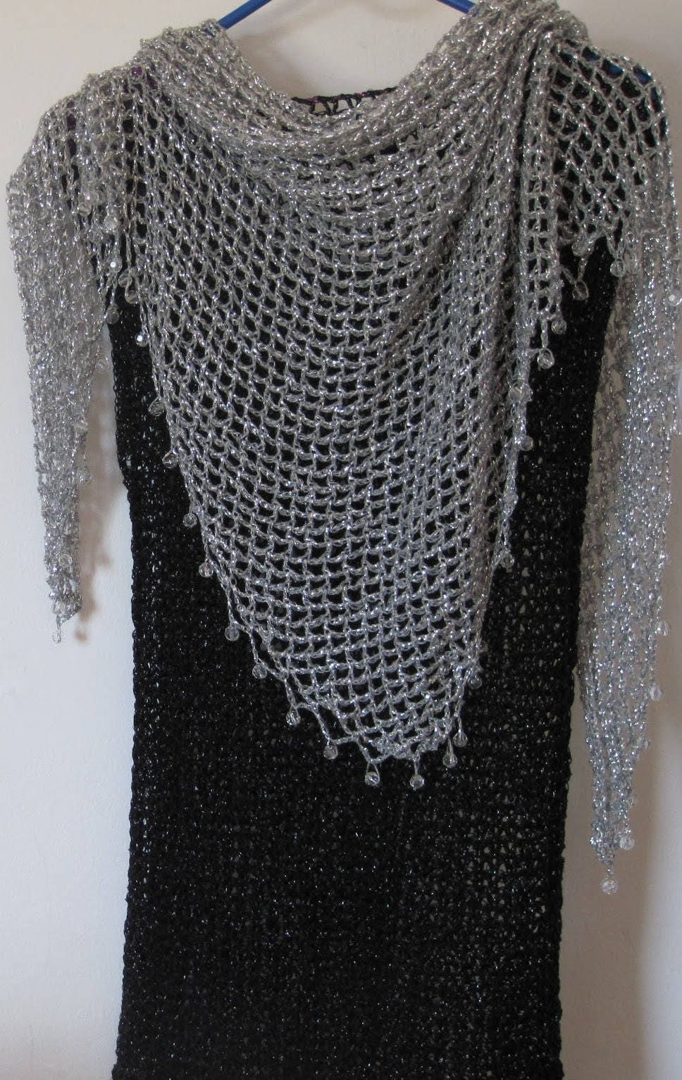 Side view of the silver shawl, the shimmering thread catching the light.