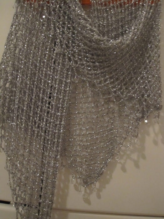 Detail of the hand stitches along the beaded edge of the silver shawl.