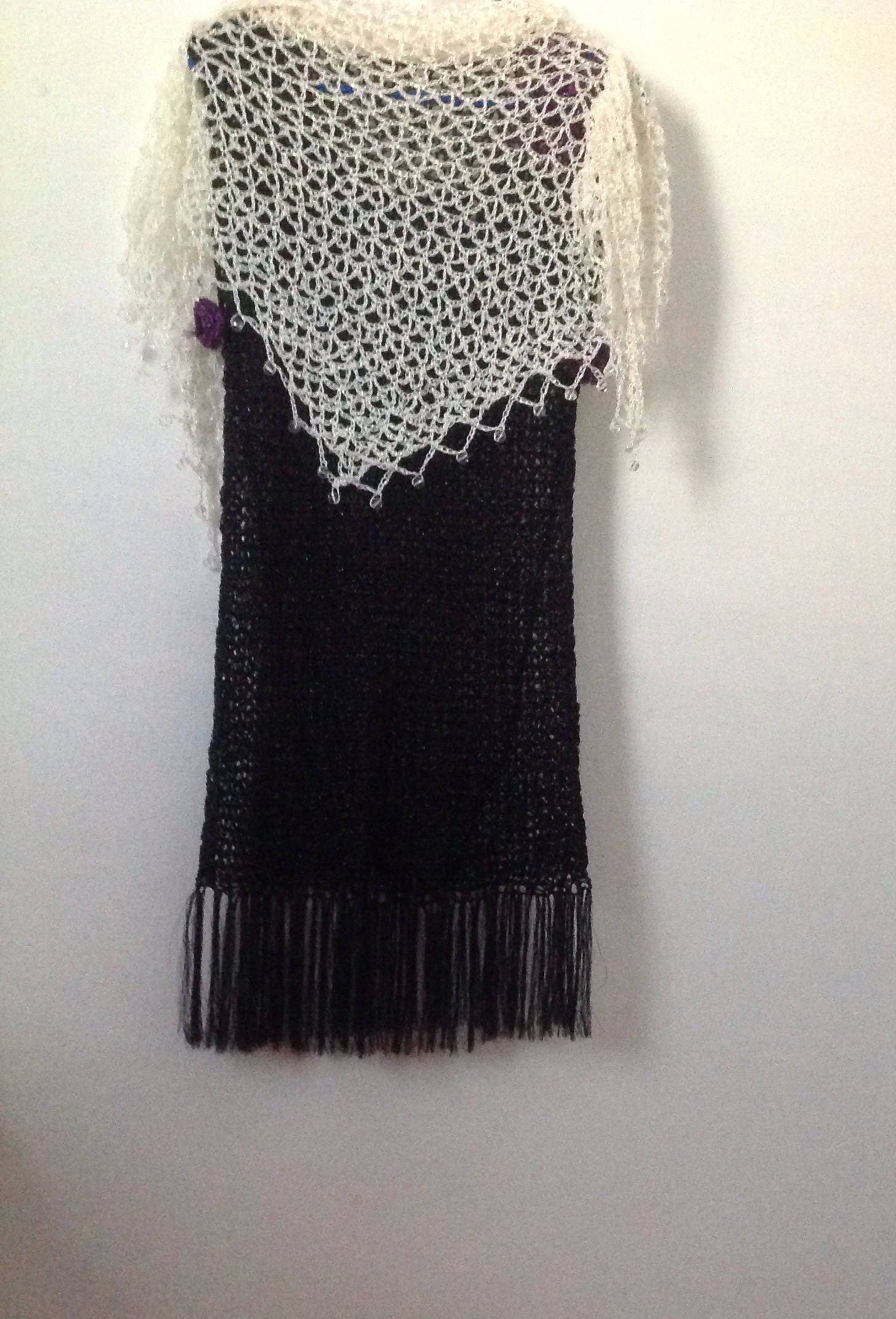 Close-up of the cream crochet openwork and beaded edge of the shawl.