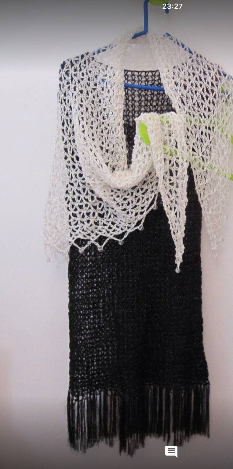 Detail of the hand stitches along the beaded edge of the cream shawl.