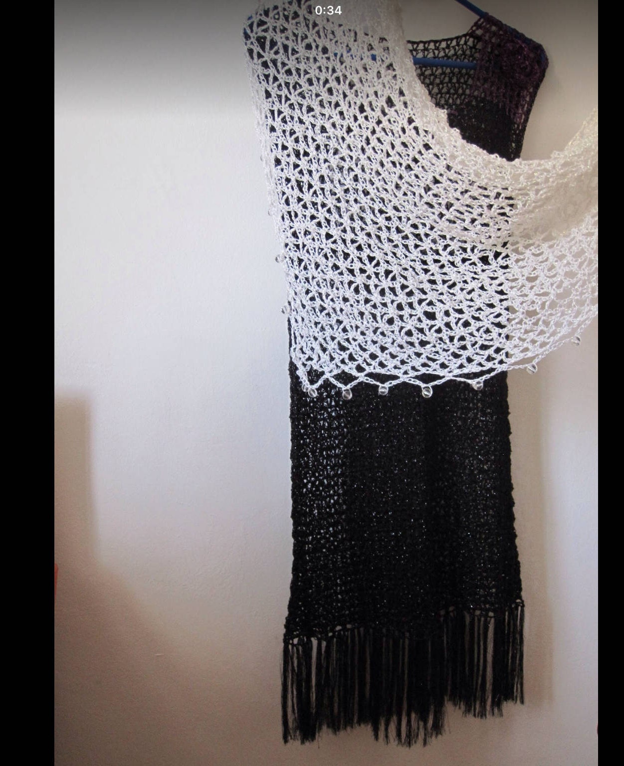 Cream shawl laid flat, showing the full triangular shape.