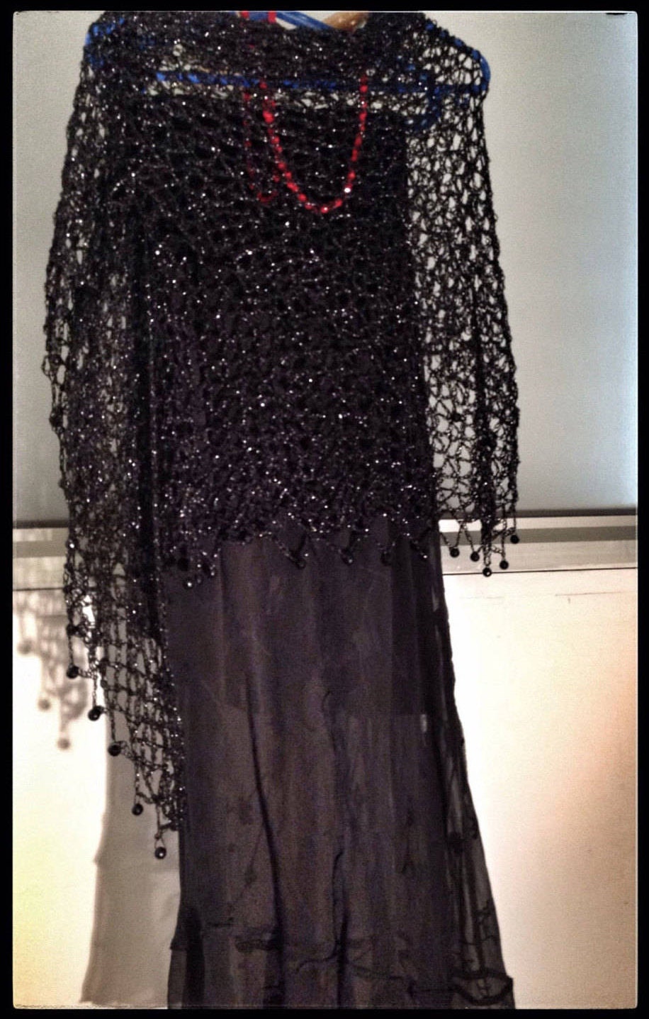 Close-up of the black crochet openwork and beaded edge of the shawl.