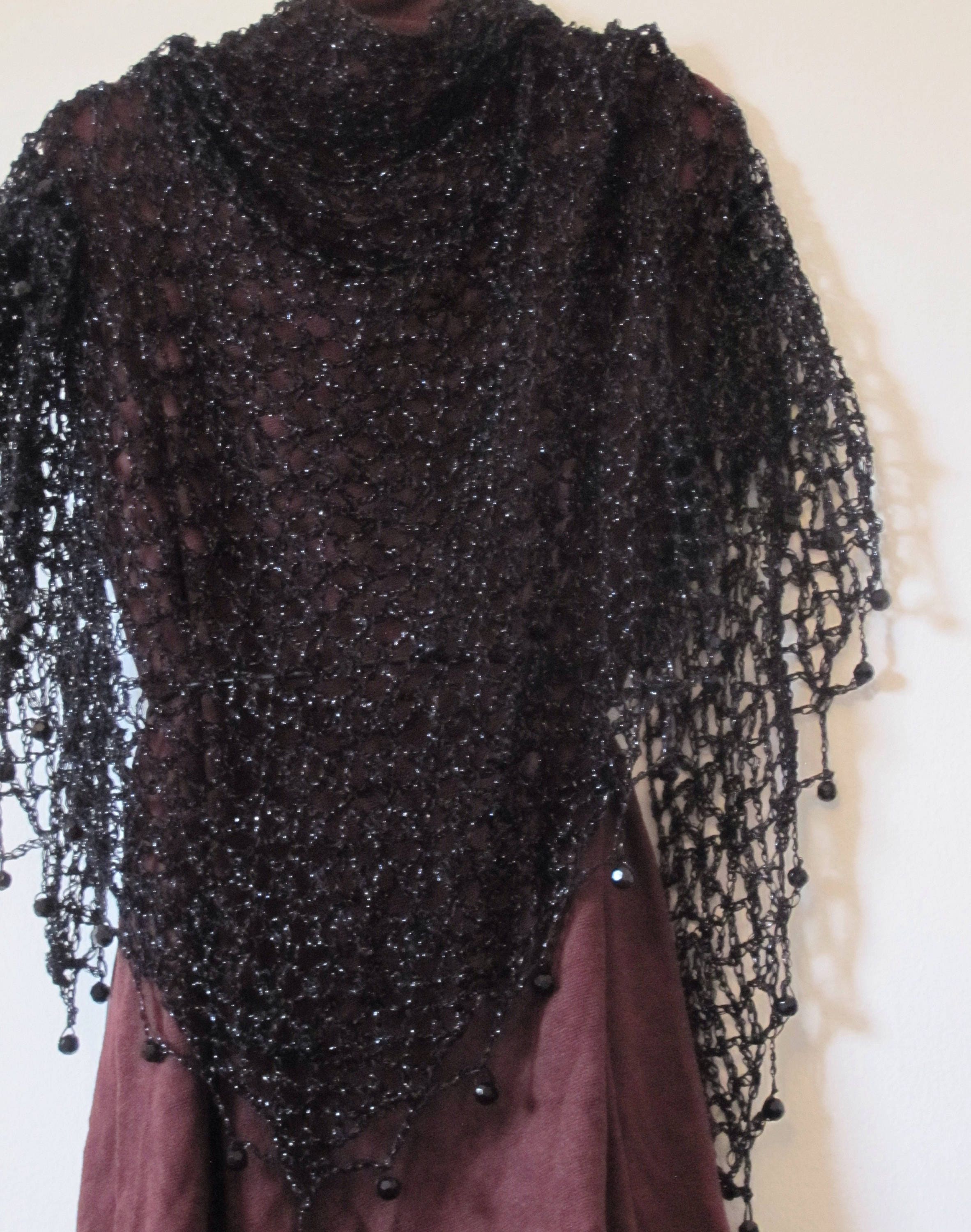 Detail of the hand stitches along the beaded edge of the black shawl.