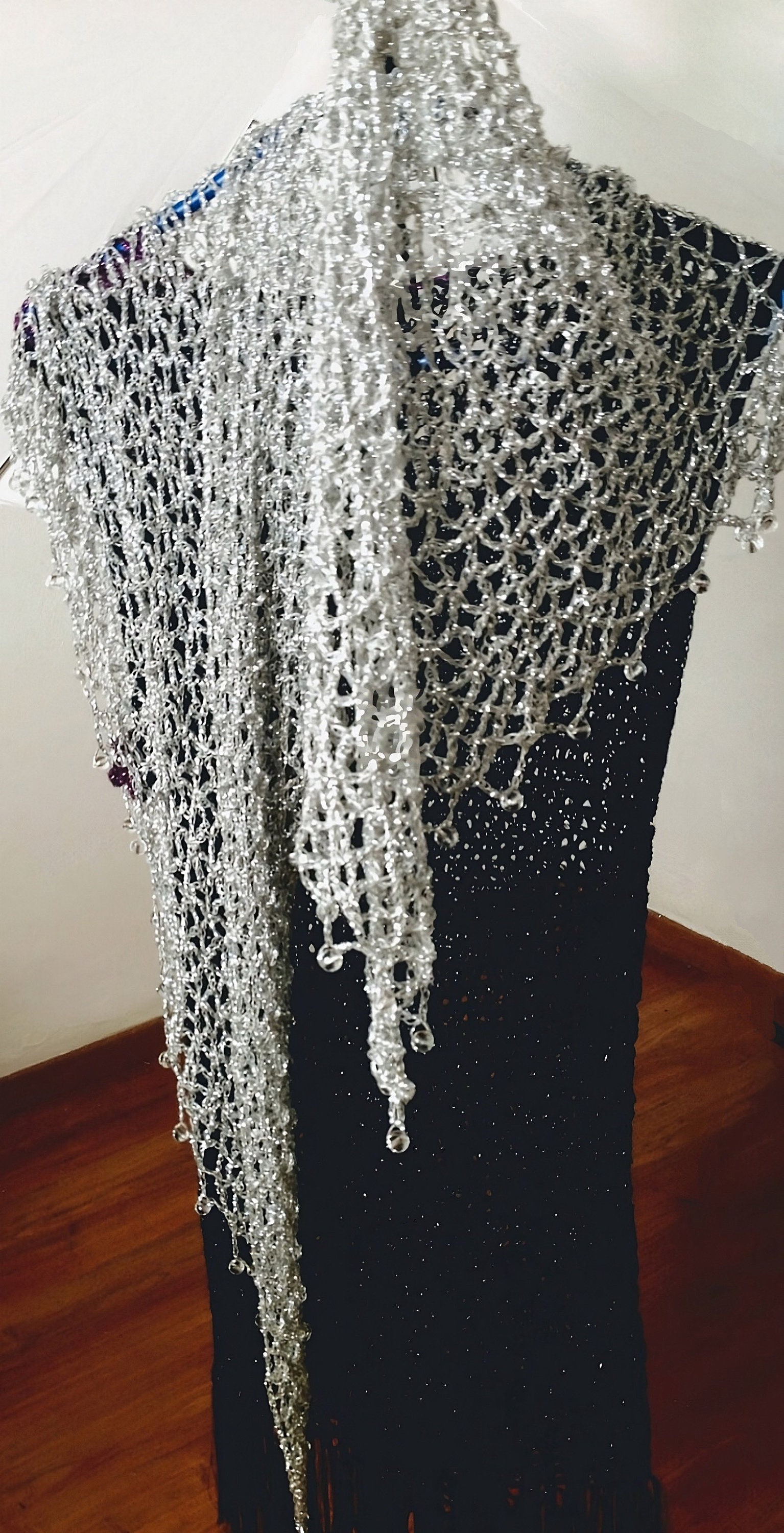 Silver shawl draped to show how it falls over the shoulders.