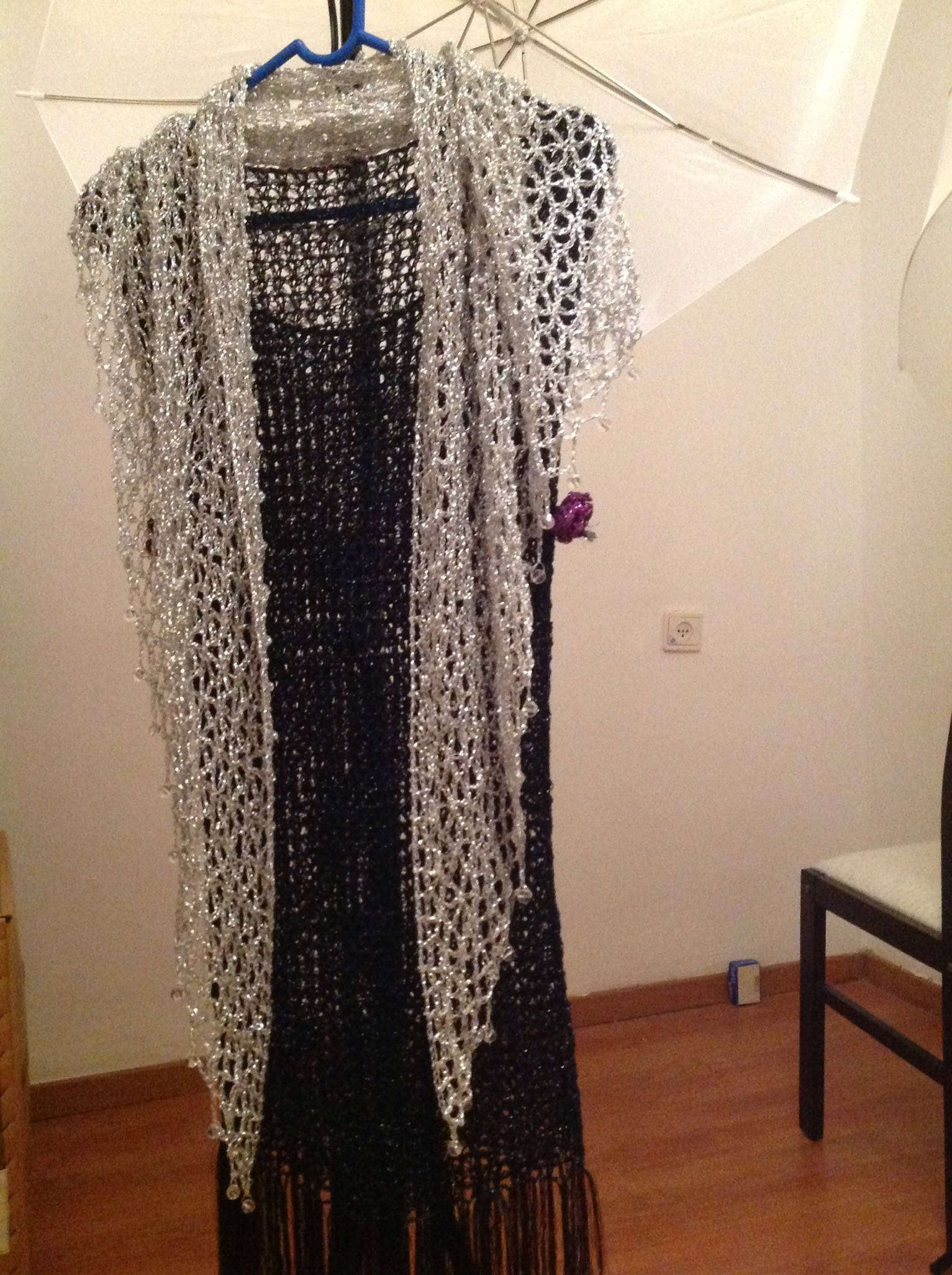 Side view of the silver shawl, the shimmering thread catching the light.