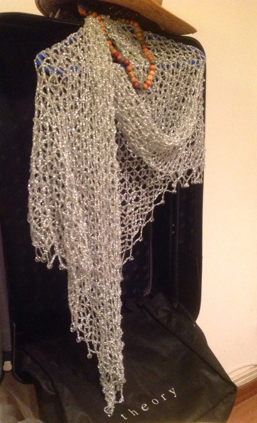 Detail of the hand stitches along the beaded edge of the silver shawl.
