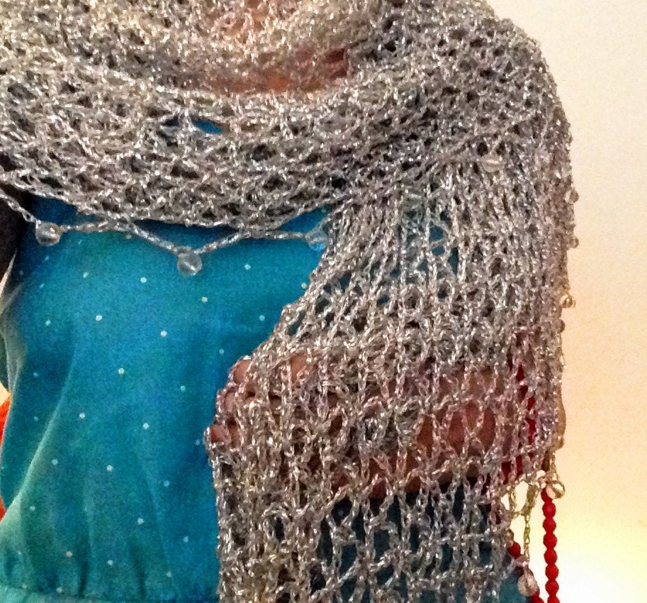Silver shawl draped to show how it falls over the shoulders.