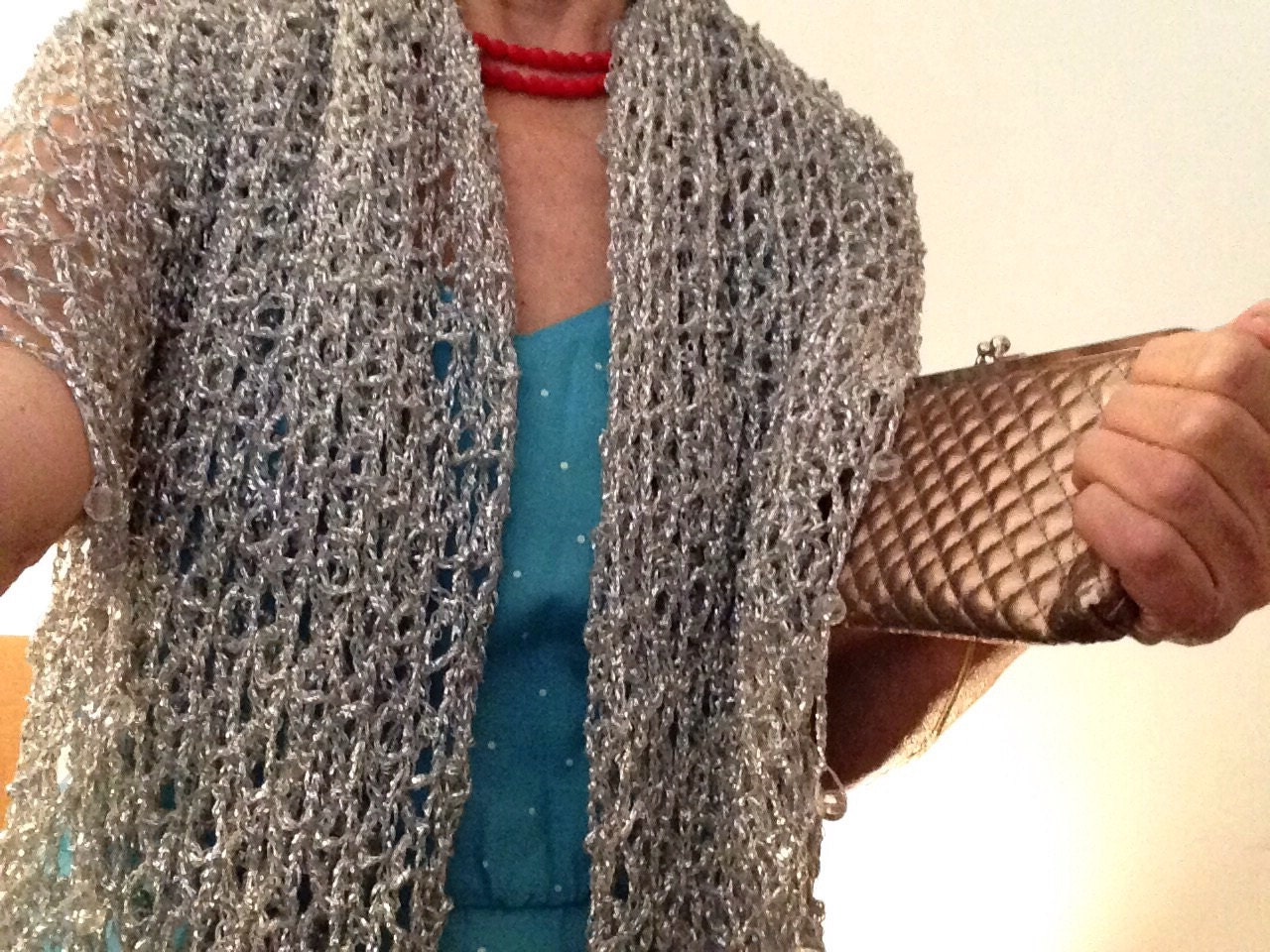 Detail of the hand stitches along the beaded edge of the silver shawl.