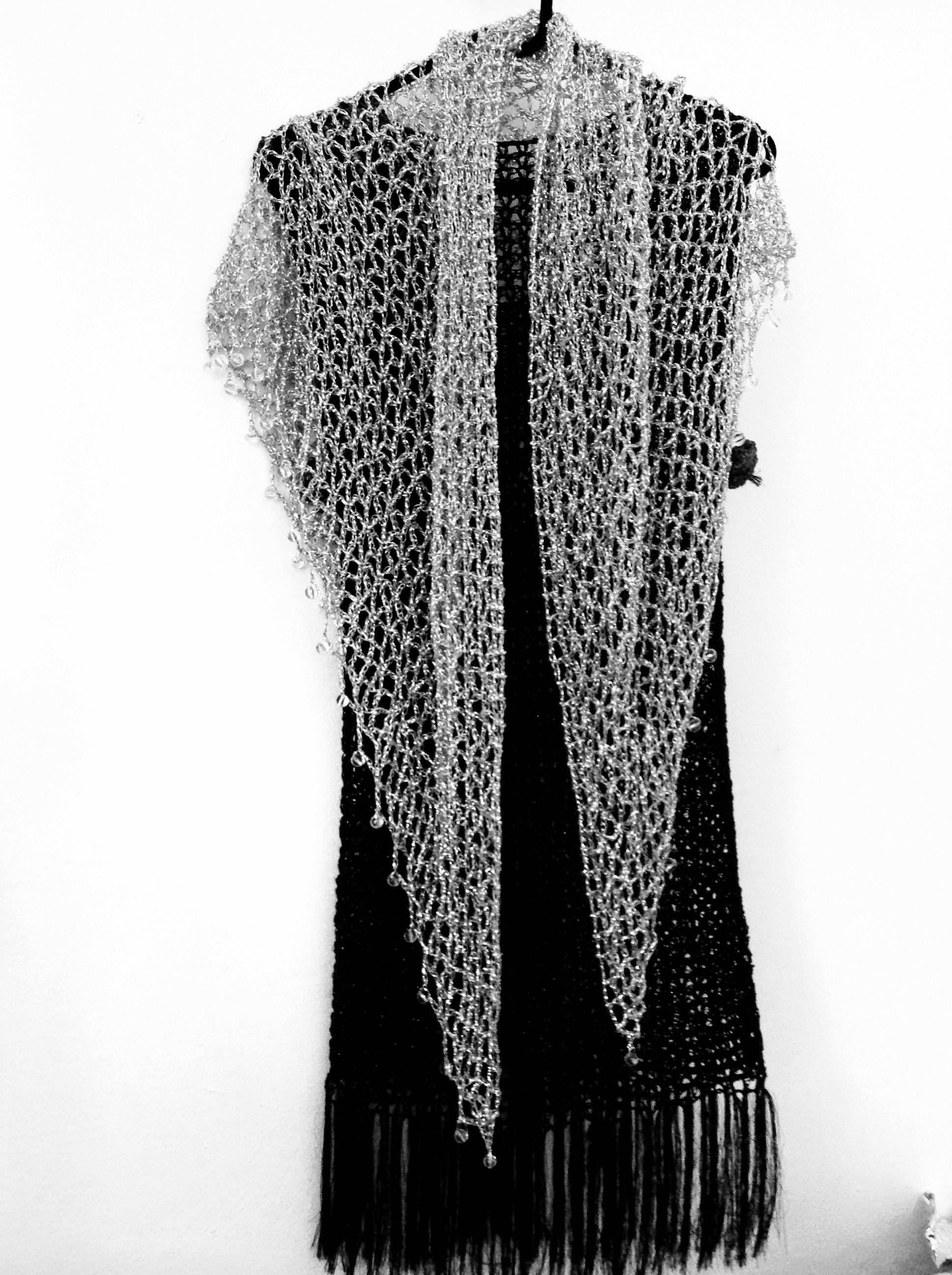 Silver shawl laid flat, showing the full triangular shape.