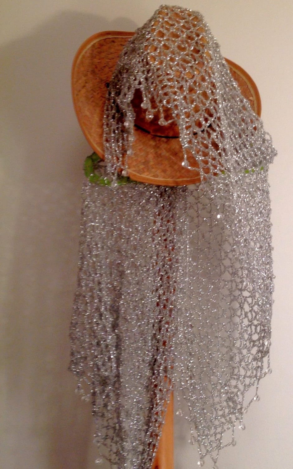 Close-up of the silver crochet openwork and beaded edge of the shawl.