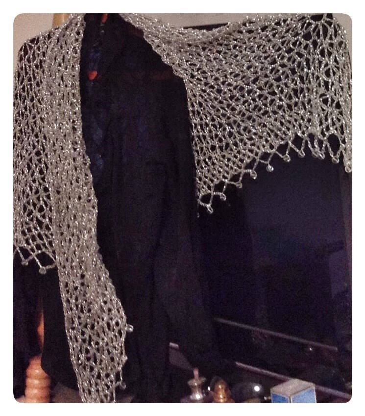 Silver shawl draped to show how it falls over the shoulders.