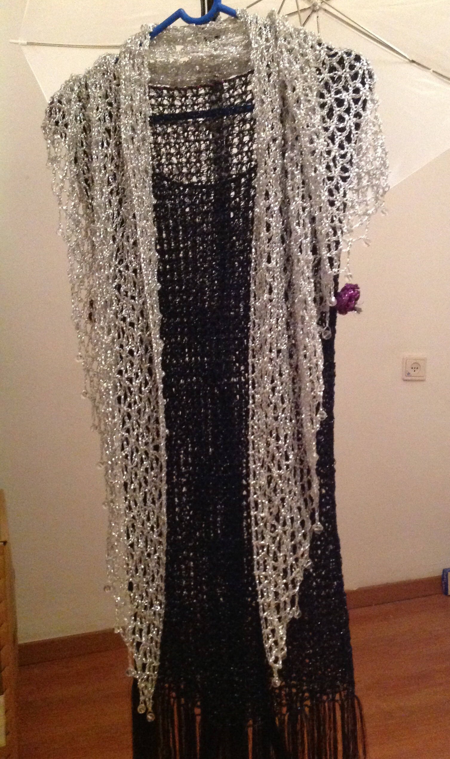 Side view of the silver shawl, the shimmering thread catching the light.