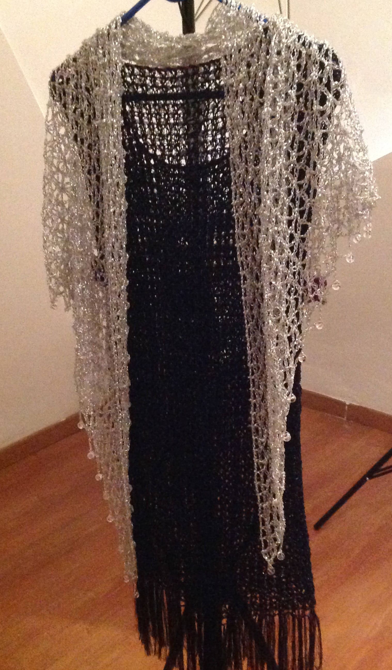 Detail of the hand stitches along the beaded edge of the silver shawl.