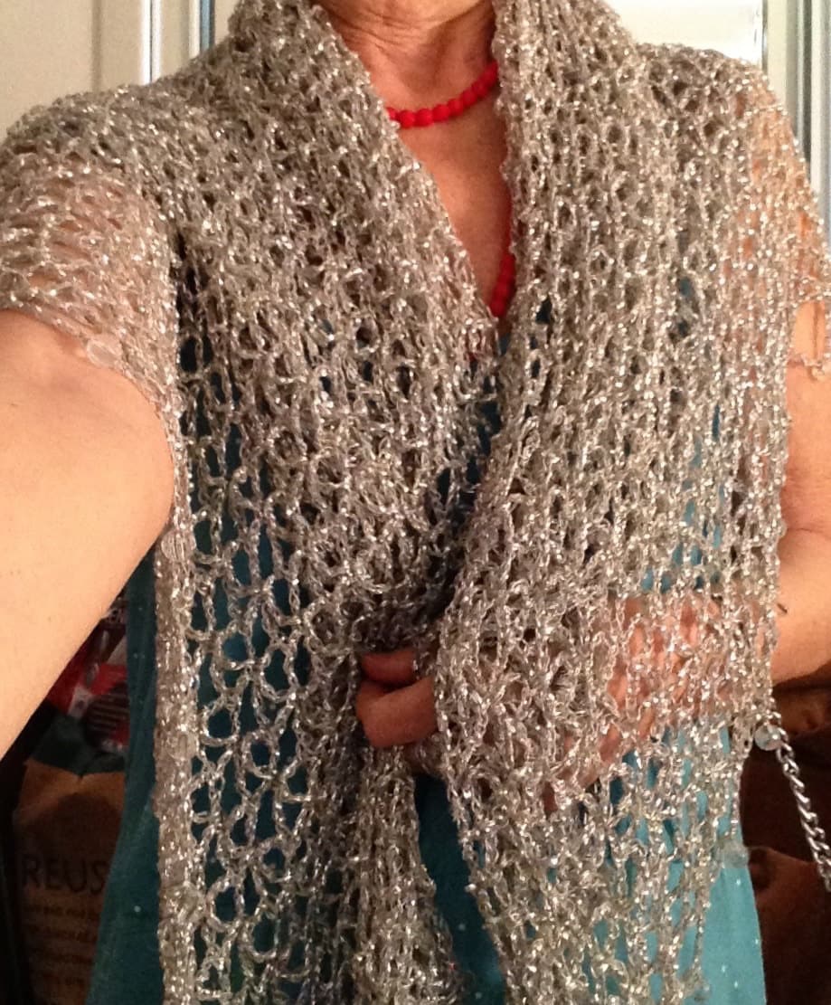 Close-up of the silver crochet openwork and beaded edge of the shawl.